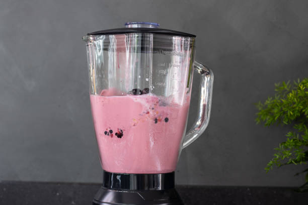 Mixer or blender at home, making a red fruit smoothie